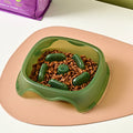 A blue plastic slow feeder dog bowl with a low 4cm profile to prevent fast eating.