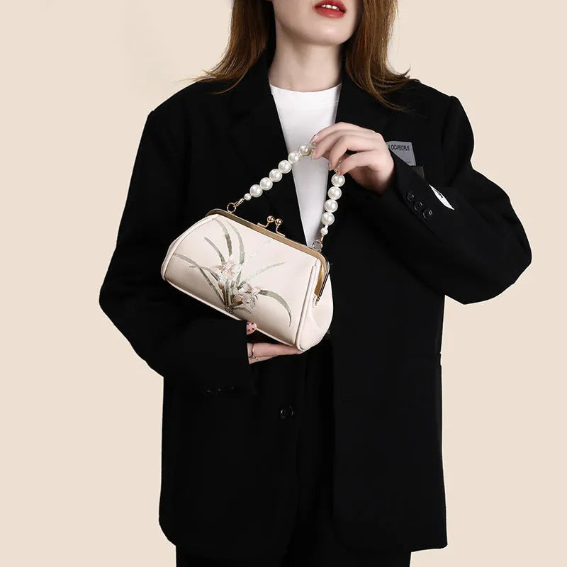 Beige women's shoulder bag with floral embroidery on soft PU leather material