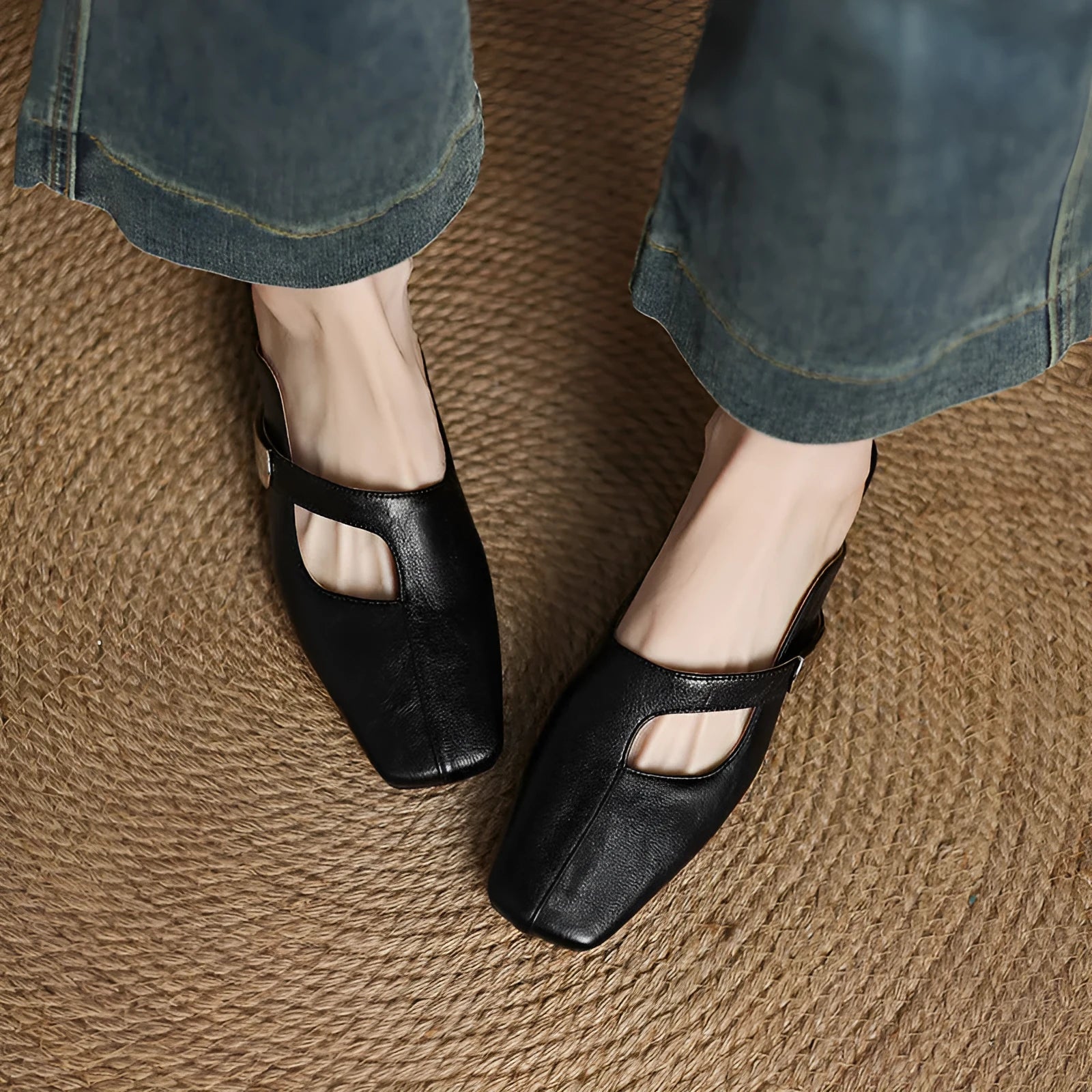 A pair of casual square-toe low-heel slippers in a solid colour on a rubber sole.
