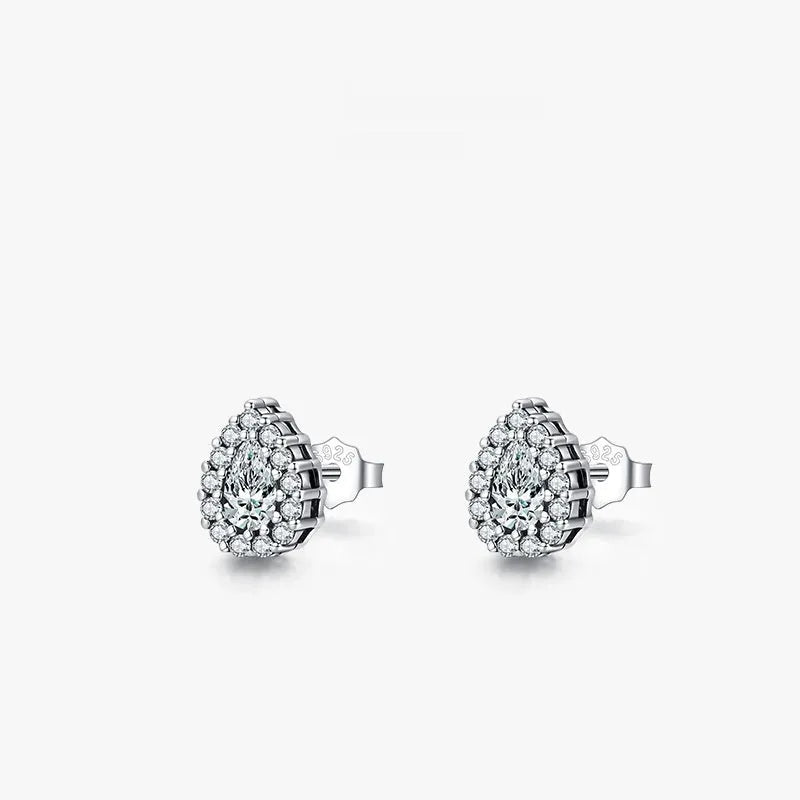 Close-up of a pair of women's silver water drop shaped ear studs on a plain background.