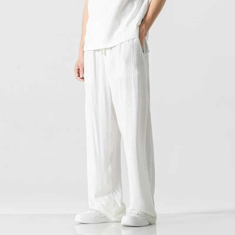Men's beige bamboo fibre linen trousers with a straight leg, cropped length, and drawstring waist.