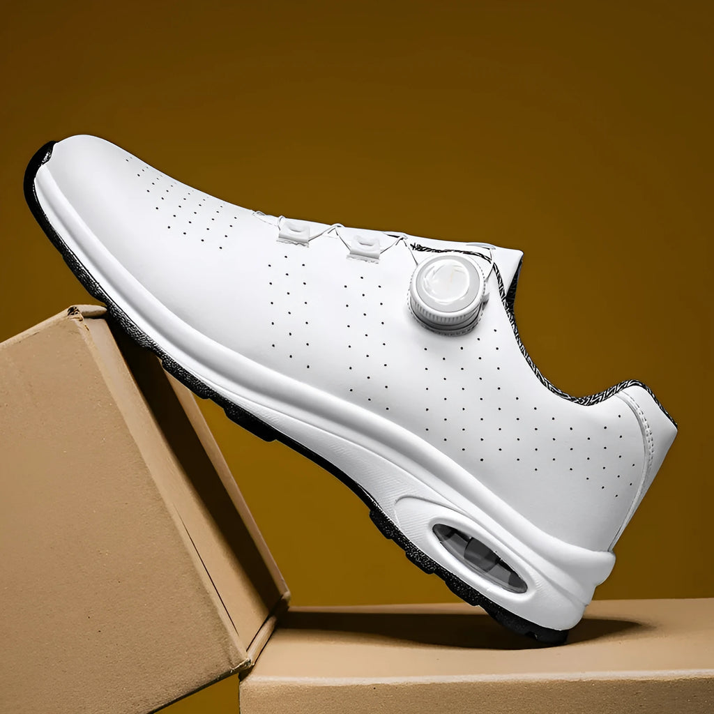 Low-top black and white mesh tennis shoes with cross-strap design and flat composite sole