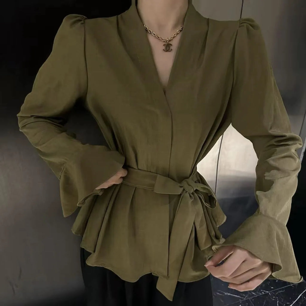 Women's black French-style shirt with an irregular collar and long bell sleeves.