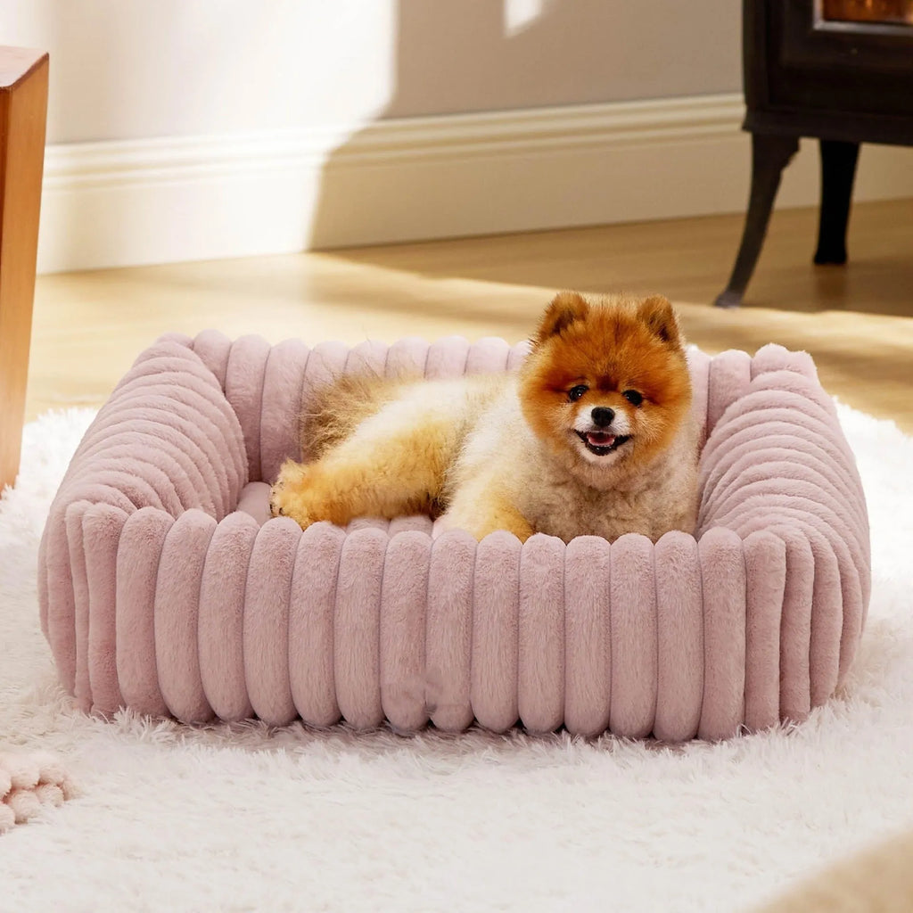 Grey pet bed with raised cushioned sides for a cat or dog.