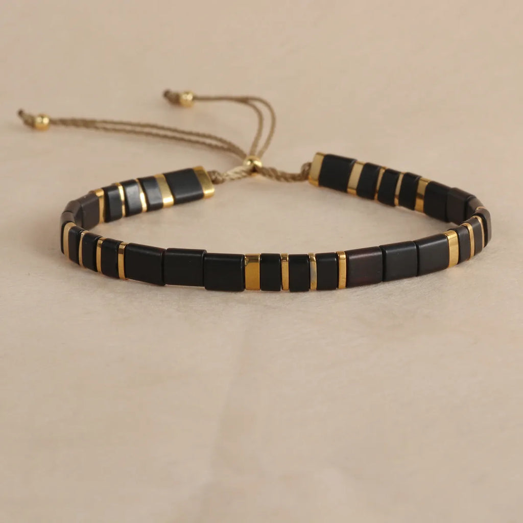 Geometric glass bead bracelet in milky white, black, retro green, light blue, or red colours.