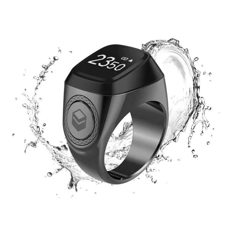 Zikr1 silver smart ring on a finger showing its OLED display and single button.
