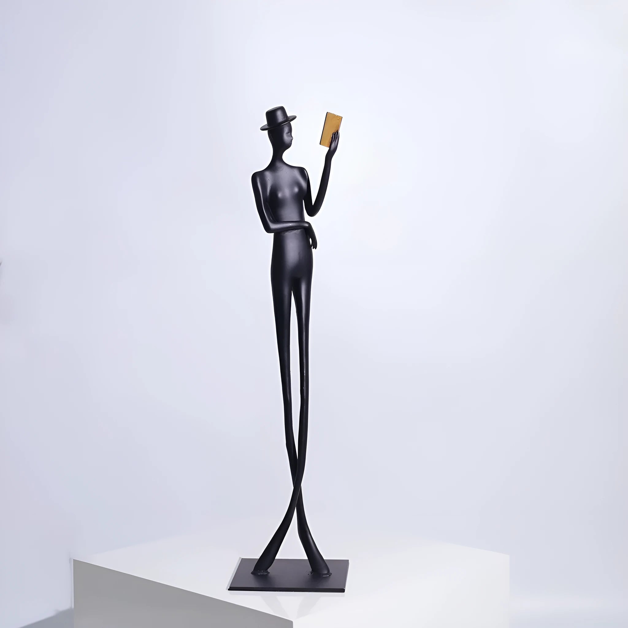 Black cast aluminium reading woman sculpture, 51cm tall modern desktop ornament.