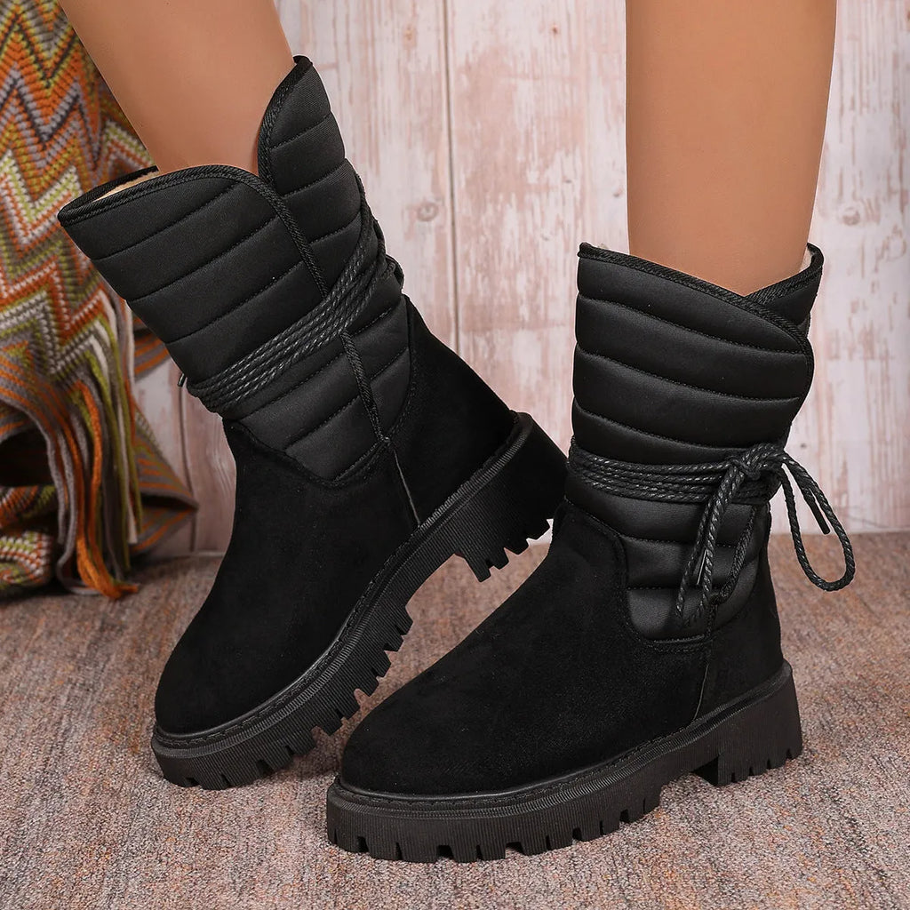 Women's black suede chunky heel mid-calf snow boot with lace-up front and fleece lining.