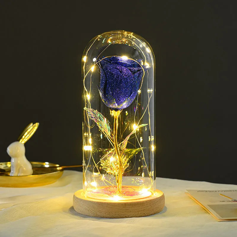Red eternal rose in glass dome with warm white LED light string on bendable copper wire