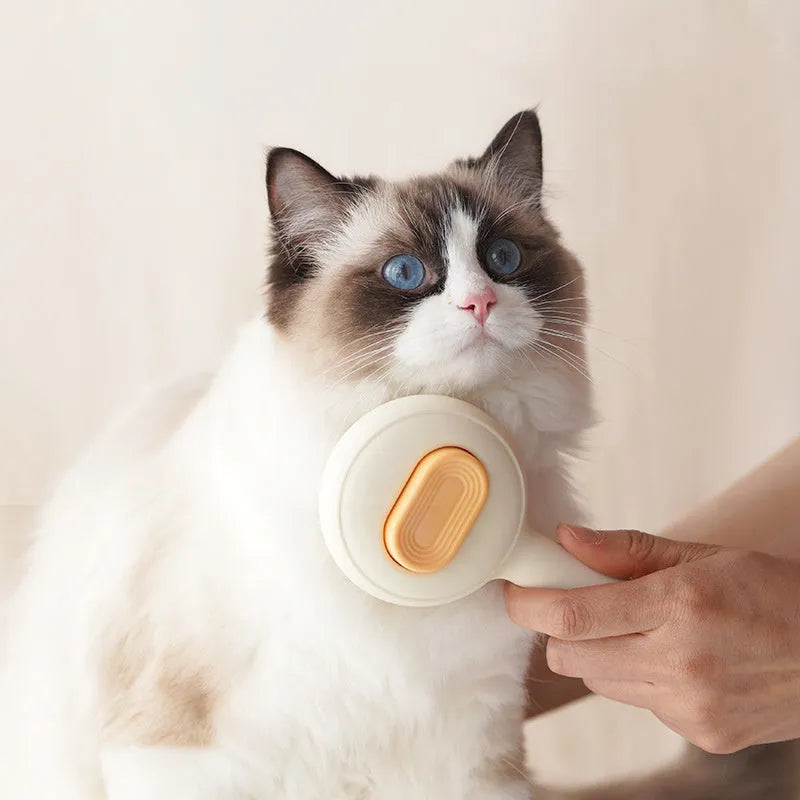 Green and yellow cat brush with stainless steel comb teeth and non-slip handle for pet grooming.