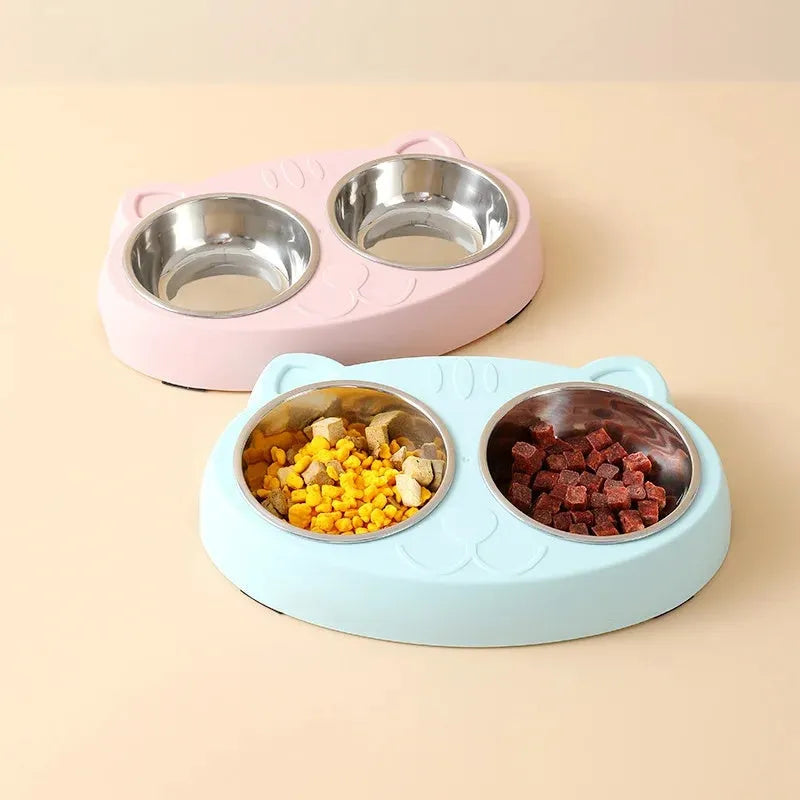Blue plastic macaron-shaped double bowl pet feeder tray with a non-slip base and centre divider.