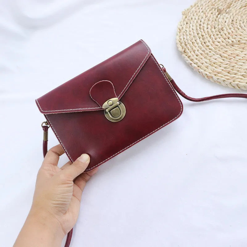 Retro messenger bag in wine red with flap closure and crossbody strap shown alongside black and light brown colour options