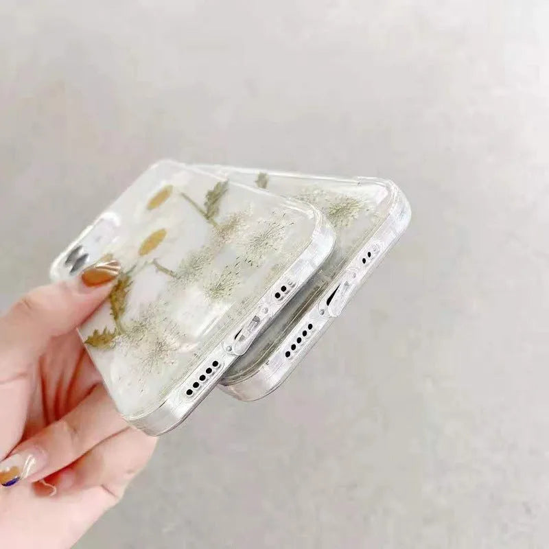 White epoxy daisy floral design on a clear TPU protective phone case for iPhone.