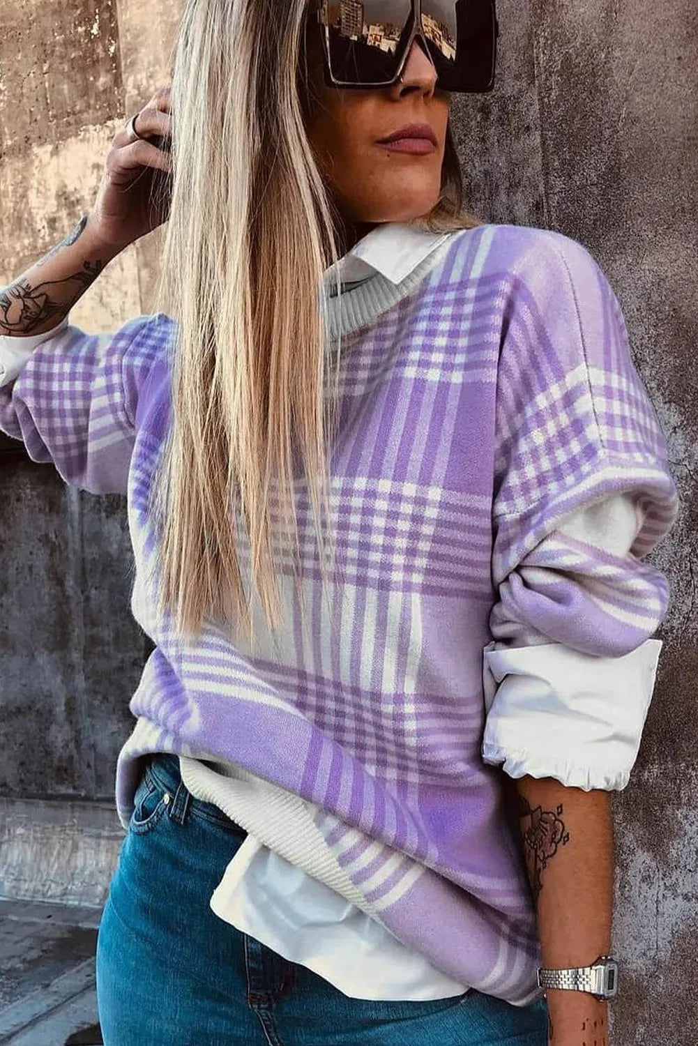 Lilac plaid print loose knit sweater with ribbed cuffs and hem on a hanger.
