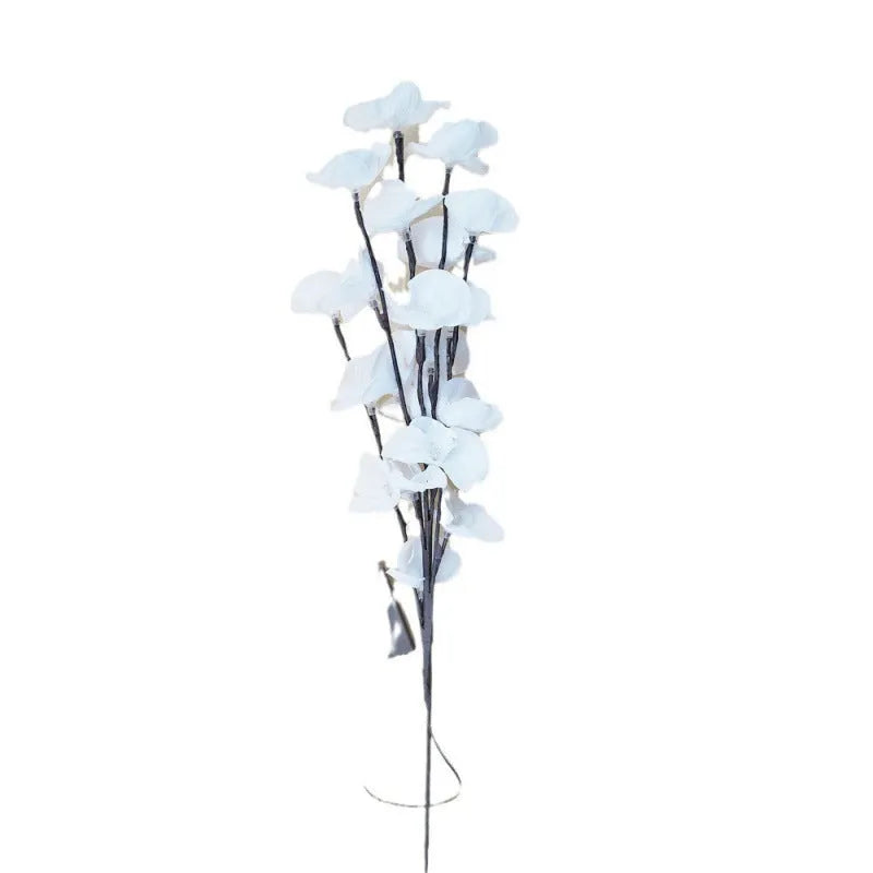 Pink LED phalaenopsis orchid branch decorative light on a table, 65 cm long with fabric leaves.