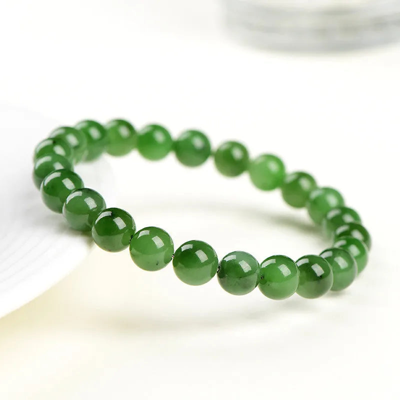 A single strand polished jasper bead bracelet in natural colours, showing different size options.