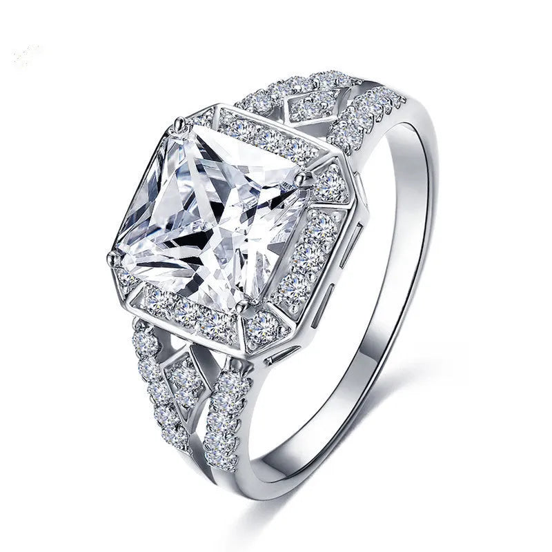 Geometric hollow zircon ring for women in platinum colour on copper, showing quadrilateral design and inlaid stones.