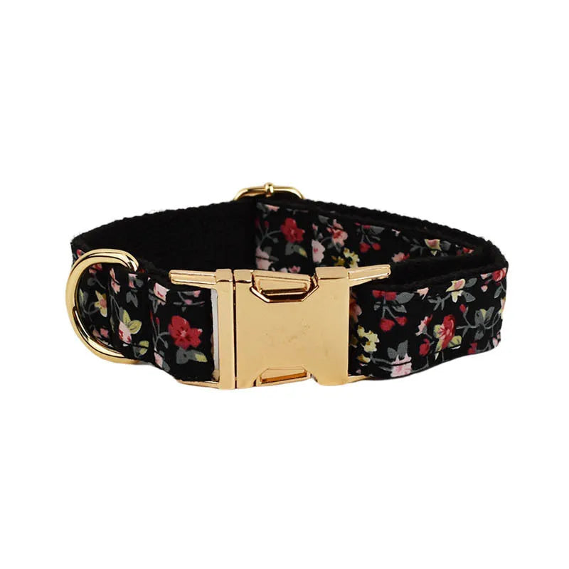 A cloth dog collar set with a removable bow, matching leash, and vest, featuring printed lettering.