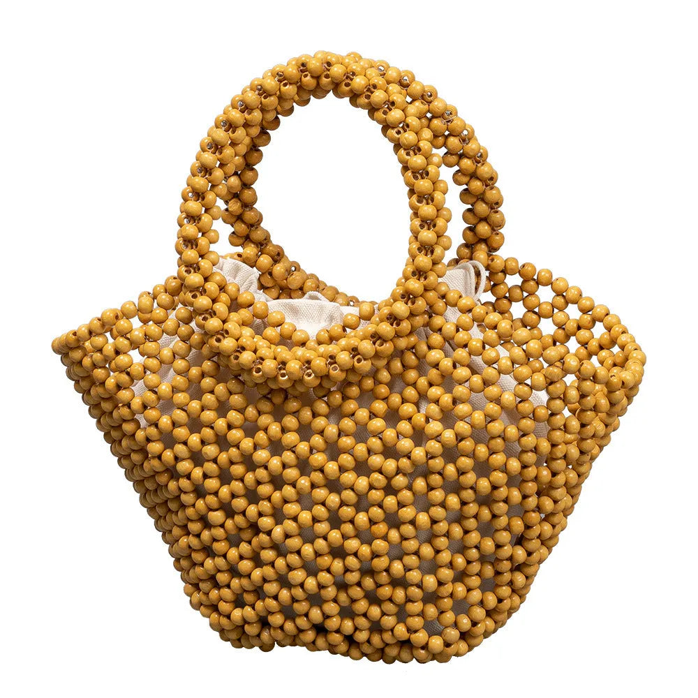 Hand-woven maple beach handbag with wooden beads in dumpling shape, shown in milky white colour
