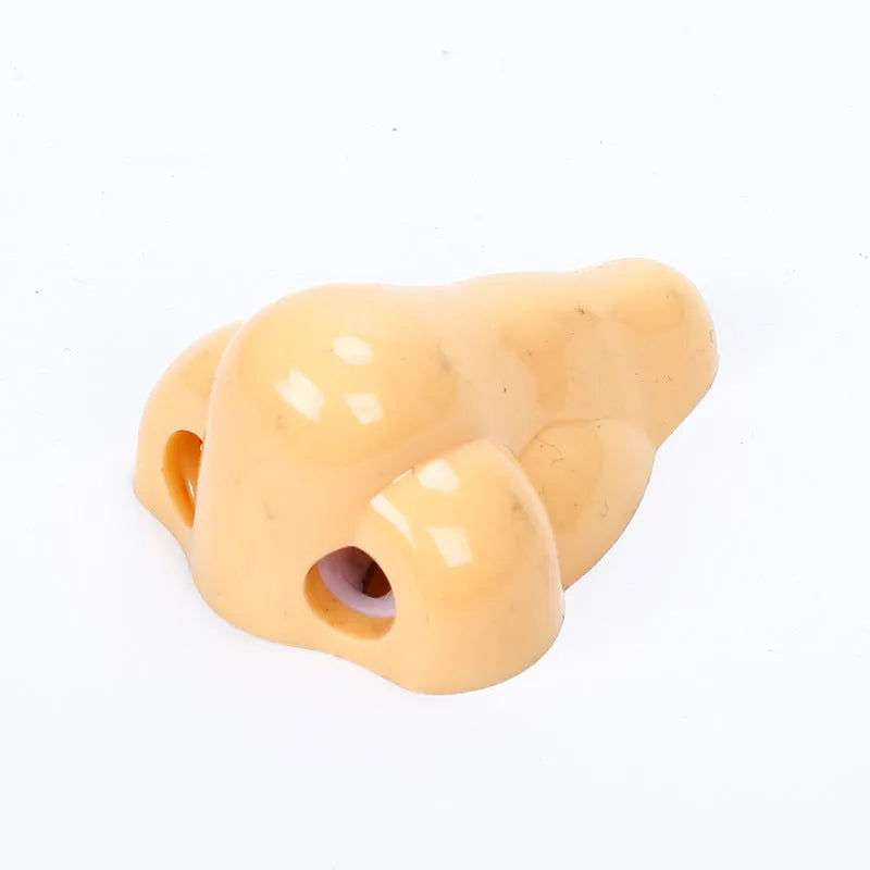 Flesh coloured plastic pencil sharpener with geometry shape on a white background.