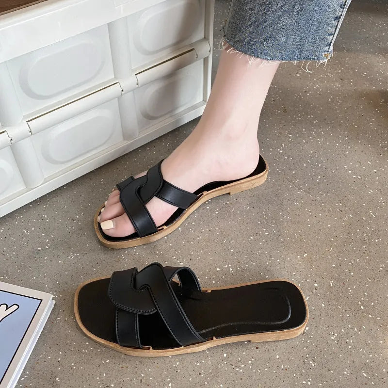Women's PVC cross strap toe ring slipper in solid colour on a plain background.