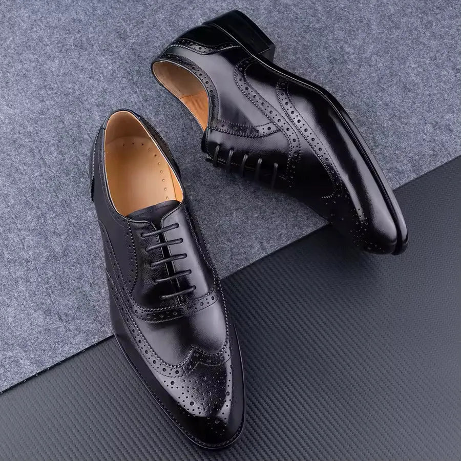 Men's purple leather oxford shoes with hand-carved detailing and a pointed toe on a rubber sole.