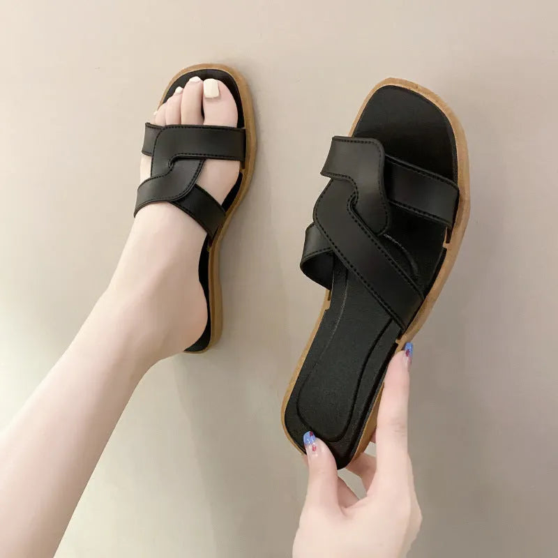 Women's PVC cross strap toe ring slipper in solid colour on a plain background.