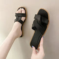 Women's PVC cross strap toe ring slipper in solid colour on a plain background.