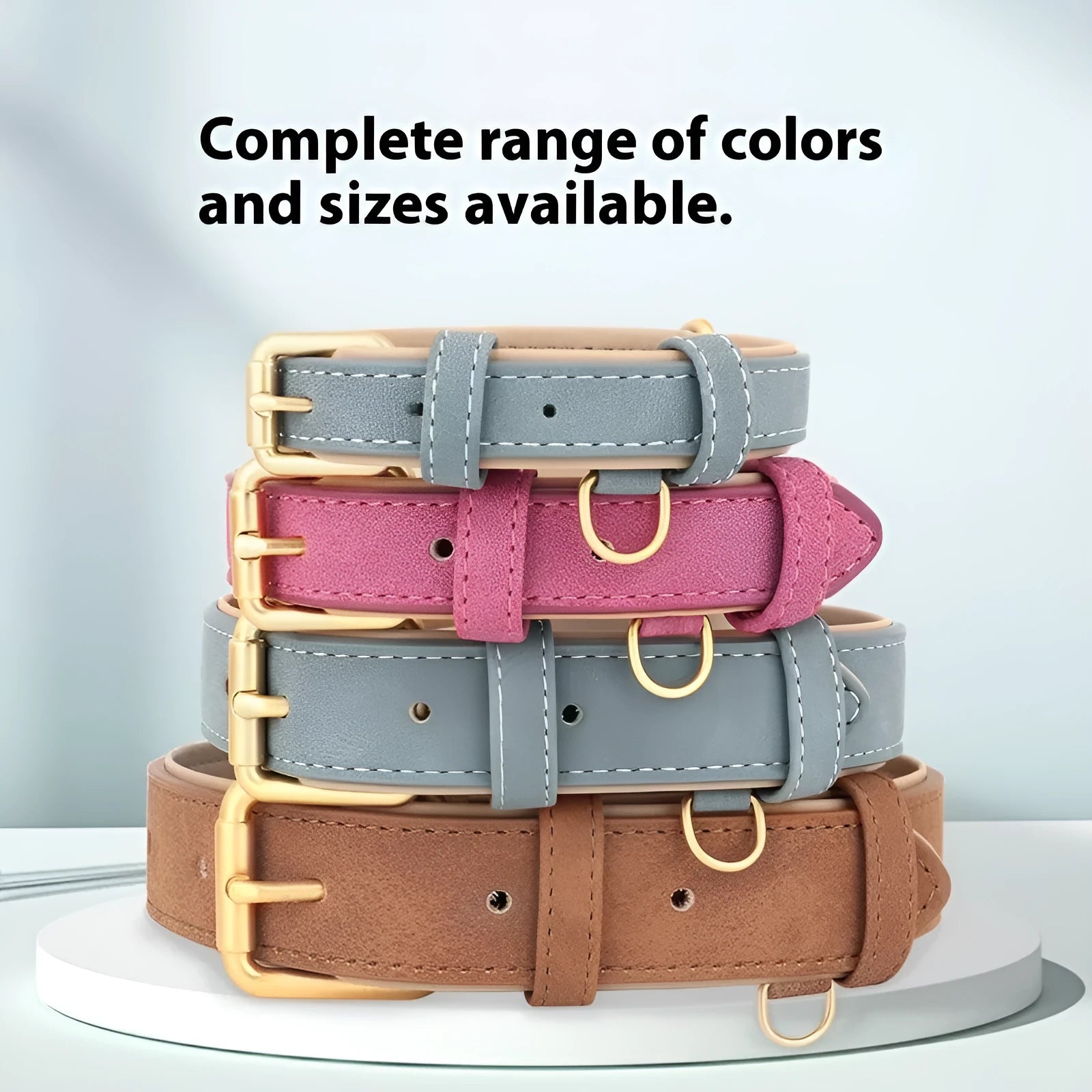 A brown double-layer leather dog collar and matching lead on a grey background, showing the adjustable buckle.
