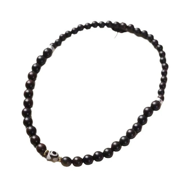 Ebony wood Tibetan prayer bead bracelet showing 8mm diameter and natural wood grain