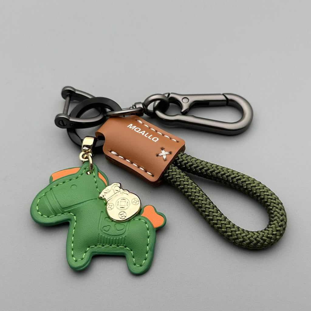 Handmade brown cowhide leather key ring pendant with a gold-toned zinc alloy pony belt buckle and green flanelle rope.