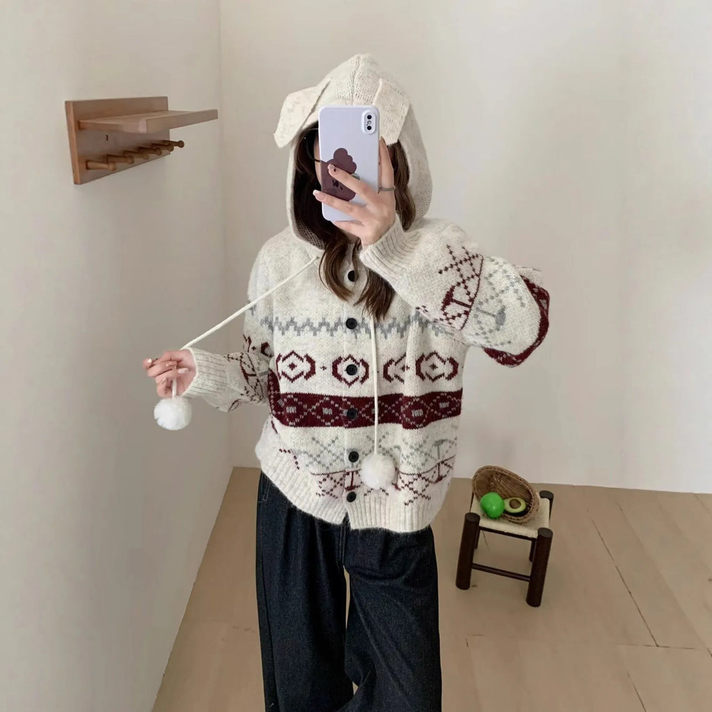 Loose grey brocade sweater coat with geometric pattern on a plus-size model.