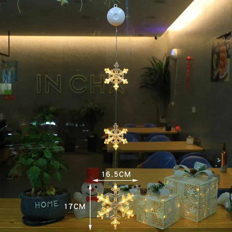 Set of three battery-powered LED Christmas pendant lights with suction cups, showing star, tree, and deer designs.