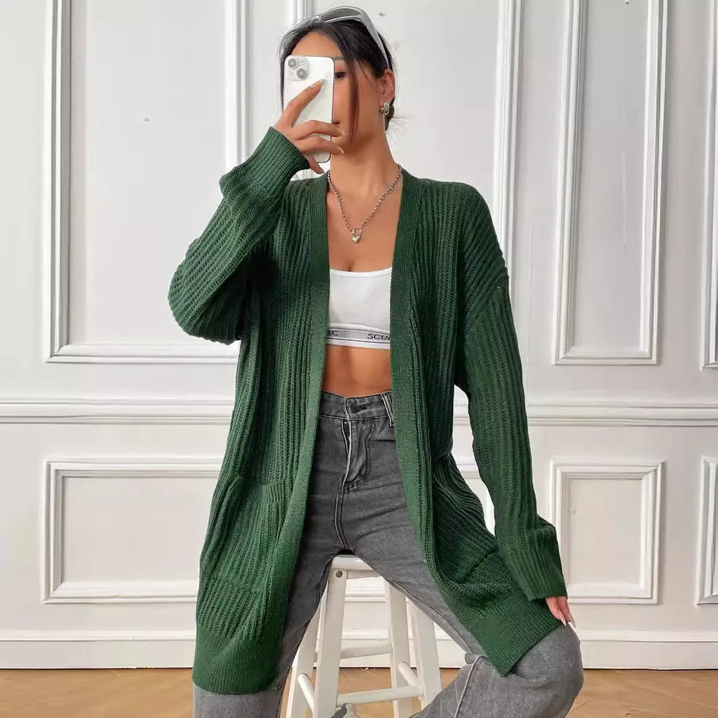 Women's dark green loose fit cardigan with two front pockets and long sleeves.