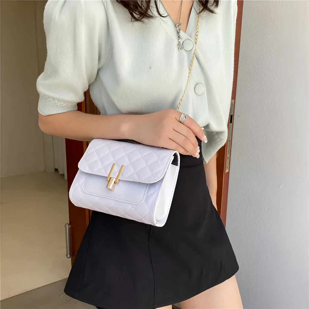 Women's black crossbody bag with diamond lattice chain strap showing 17.5cm width dimensions