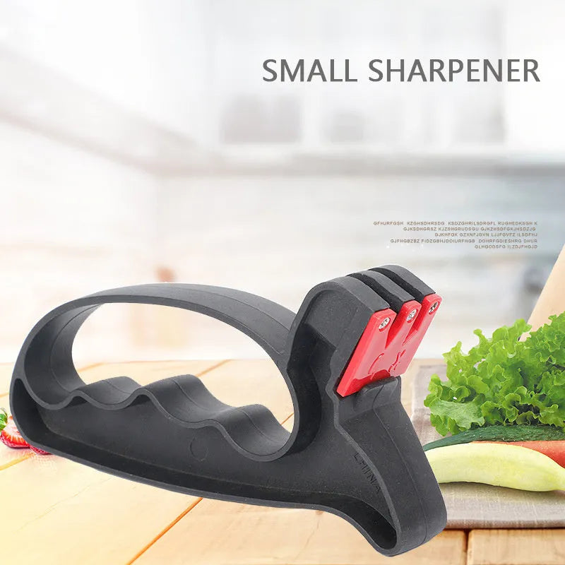 Black handheld knife and scissor sharpener tool on a white background.