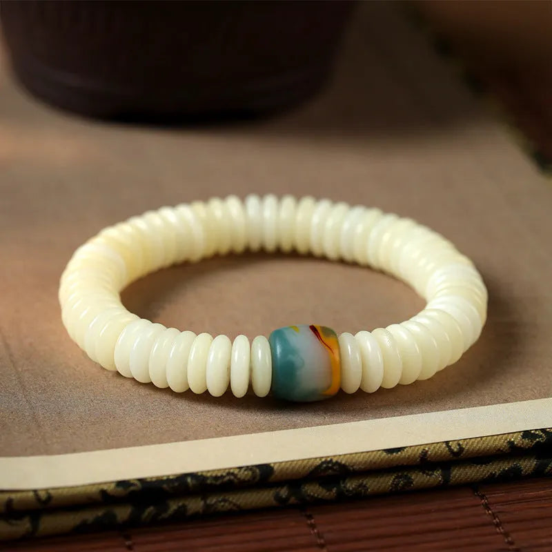 White Bodhi seed Tibetan bracelet showing 3x10mm dimensions in bracelet and handheld styles