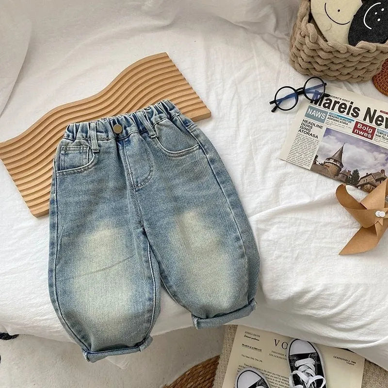 Light-coloured boys denim jeans with printed back pocket and elastic waist, front view