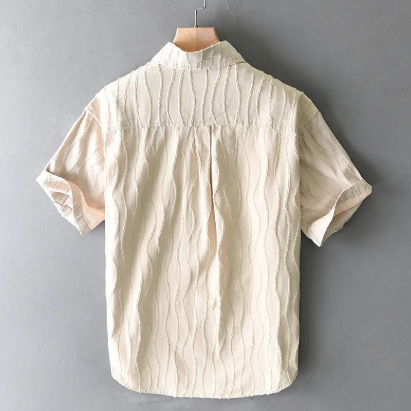 Men's apricot pure cotton short sleeve casual shirt with loose fit on a hanger.