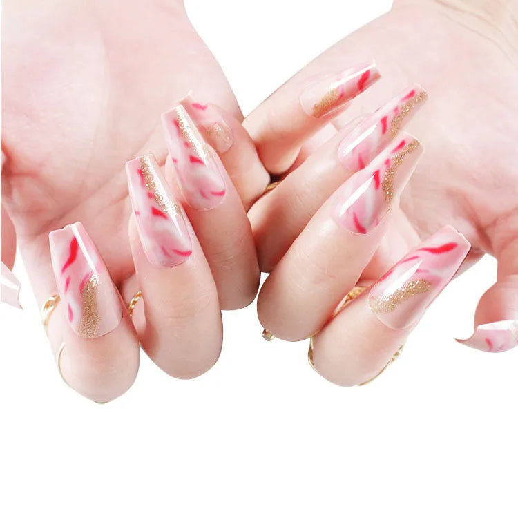 Set of medium-length false nails showing rose, tulip, leopard print, and XINGX patterns with glue.