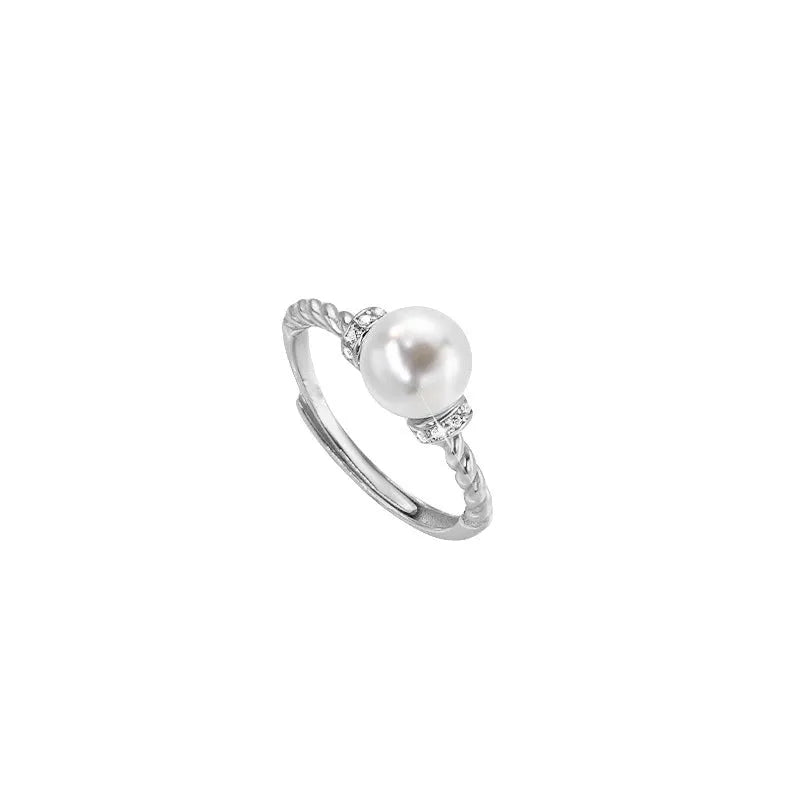 Adjustable copper ring with antique twist design and inlaid pearl in gold finish.