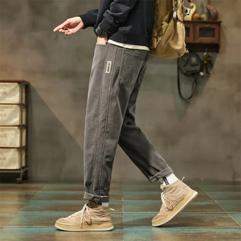 Men's army green corduroy casual trousers with a tapered straight-leg fit on a mid waist.
