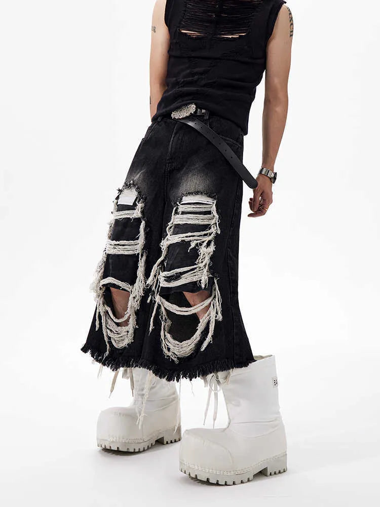 Black women's cropped wide-leg jeans with ripped patch details on the legs.