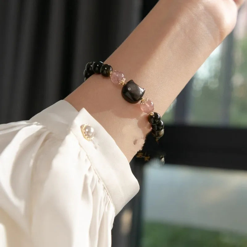 Black obsidian 8mm bead bracelet with silver kitty charms on adjustable closure