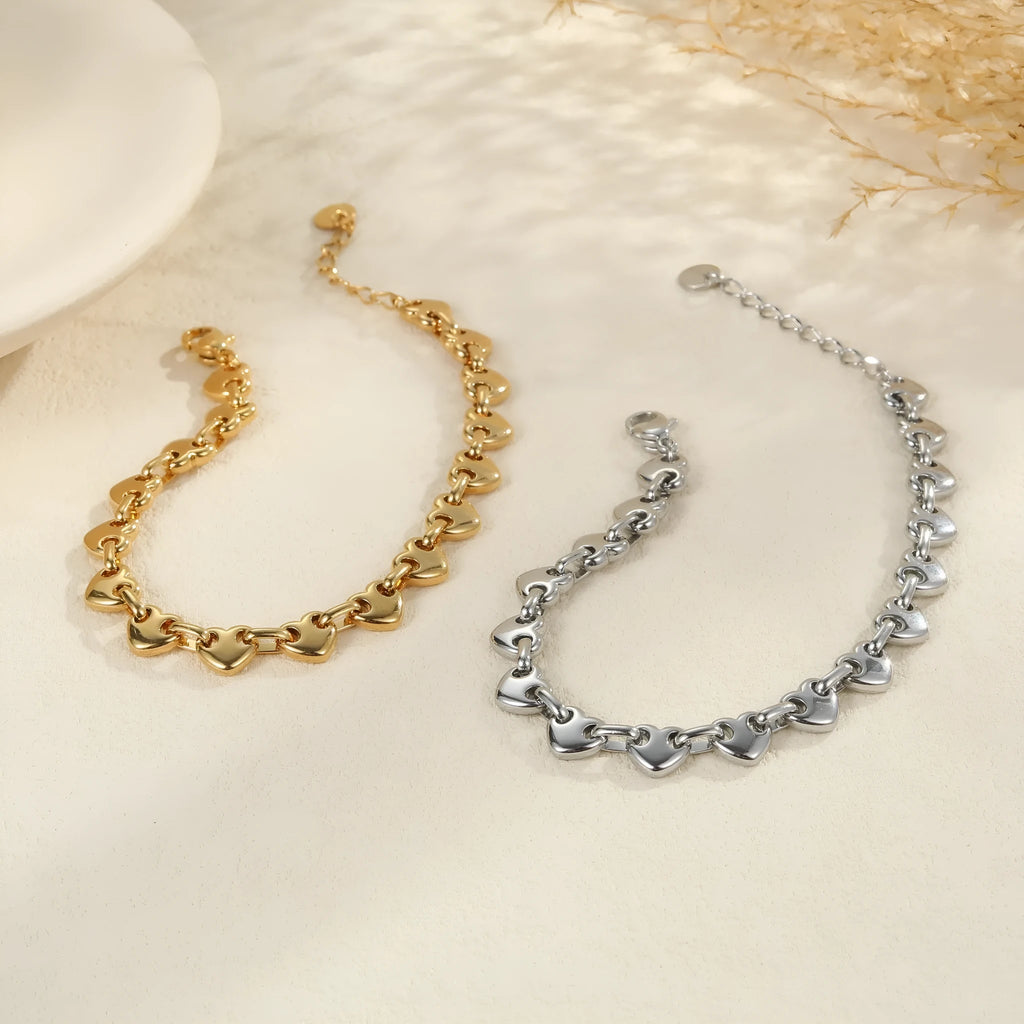 Women's stainless steel hollow heart bracelet in gold, steel, or colour blocking with electroplated finish.