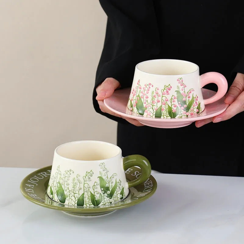 Ceramic coffee cup and saucer set for two with stirring spoons in Hanging Bell or Lanling Grass patterns.