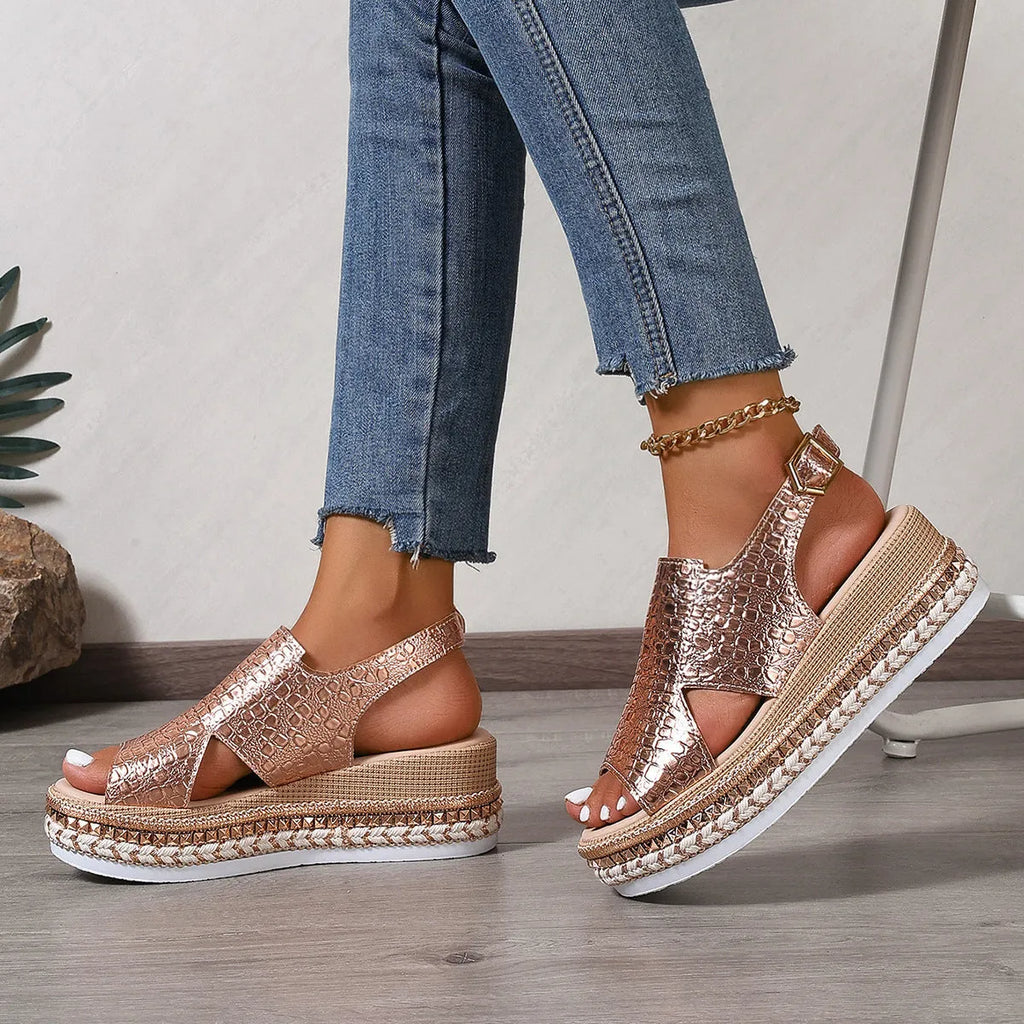 Gold women's Roman sandals with round toe, hollow-out upper, and an ankle buckle.