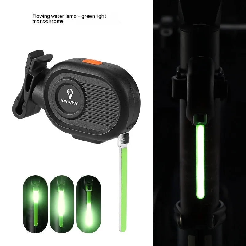 Bicycle taillight displaying a blue waterfall or running water light effect on a dark background.