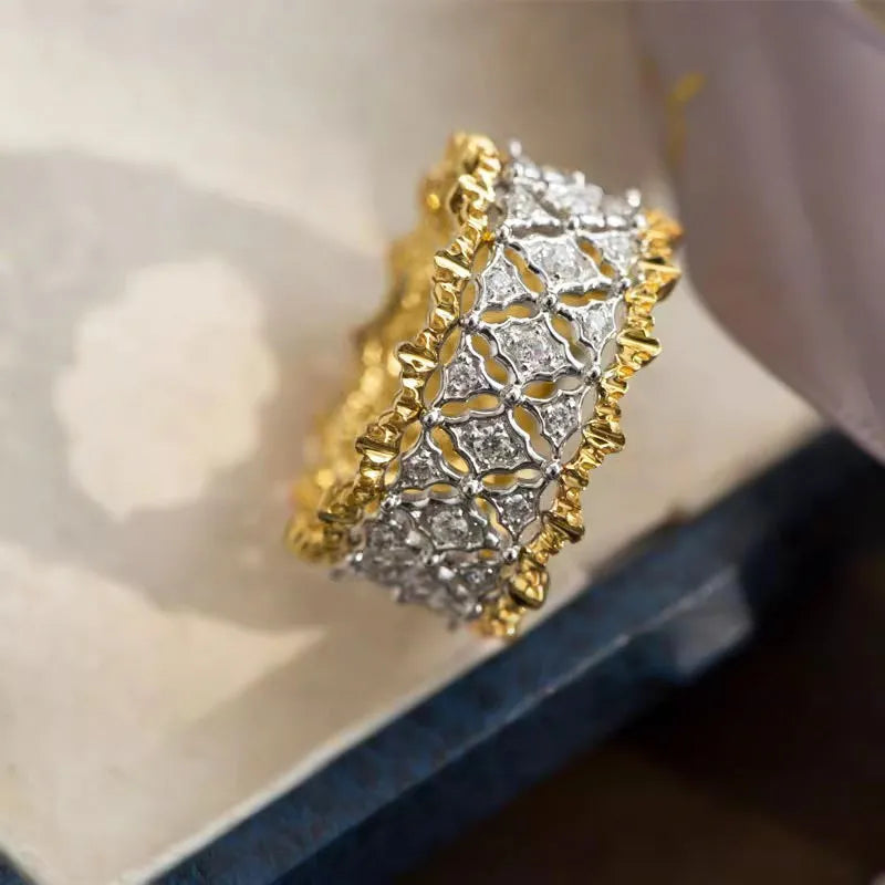 Geometric two-tone zircon copper ring showing electroplated finish and round stone elements.