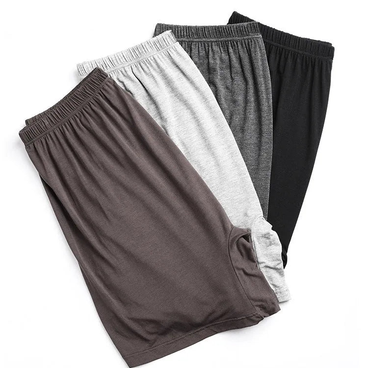 Man wearing solid colour high waist modal boxer shorts in a neutral shade.